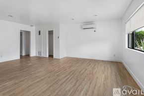 Los Angeles apartment for rent - A spacious room with wooden flooring and white walls.