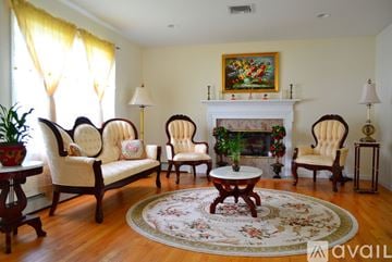 Lindenhurst apartment for rent - A living room with a fireplace and a painting above it.