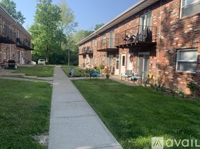 Pacific apartment for rent - A long concrete walkway leads between two rows of red brick apartment buildings.