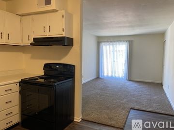 Pacific apartment for rent - A kitchen with white cabinets and a black stove top oven.
