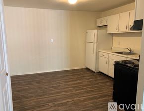 Pacific apartment for rent - A kitchen with white cabinets and a black dishwasher.
