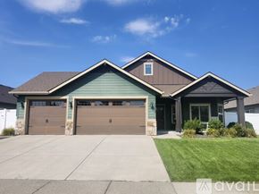 Hayden house for rent - A house with a brown garage door is for sale.