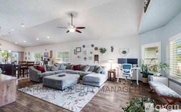 Hayden house for rent - A living room with a grey sofa set, a white chair, and a ceiling fan.