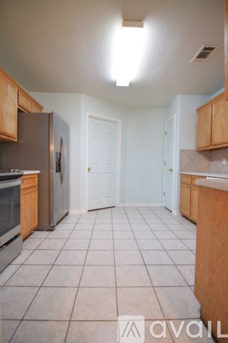 Killeen house for rent - A kitchen with wooden cabinets and stainless steel appliances.