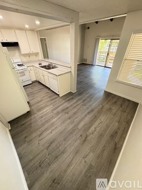 Azusa apartment for rent - A room with wooden flooring and a window with blinds.