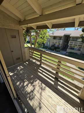 Azusa apartment for rent - A wooden deck with a view of a house and trees.