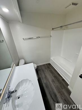 Azusa apartment for rent - A room with a wooden floor and white walls.