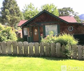 Gold Hill house for rent - A house with a green door and a wooden fence in front.