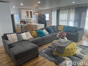 Newark apartment for rent - A bedroom with a bed, dresser, and a television.