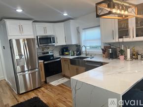 Newark apartment for rent - A kitchen with white cabinets and a stainless steel refrigerator.