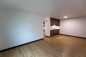 Bismarck apartment for rent - A room with wooden floors and white walls.