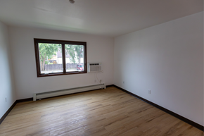Bismarck apartment for rent - A room with a window and wooden flooring.
