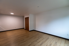 Bismarck apartment for rent - A room with a wooden floor and a brown door.