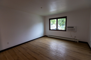 Bismarck apartment for rent - A room with wooden floors and a window.