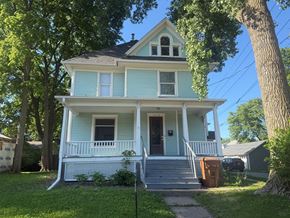Grinnell apartment for rent - A blue house with white trim and a brown door.