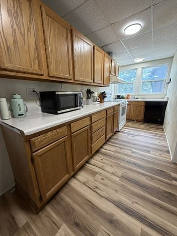 Grinnell apartment for rent - A kitchen with wooden cabinets and a white countertop.