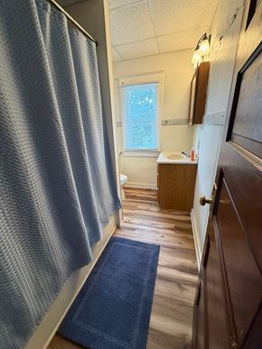 Grinnell apartment for rent - A blue bathroom mat is on the floor.