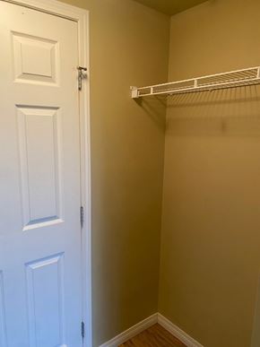 Edmonton apartment for rent - A white door is open to a small closet with a shelf.