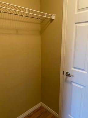 Edmonton apartment for rent - A white door is on the right side of a wall with a white shelf above it.