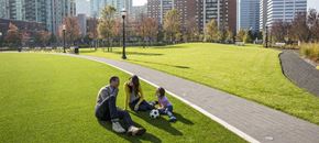 Jersey City apartment for rent - a family playing with a soccer ball in a park