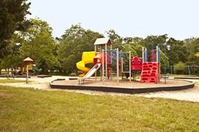 Somerset apartment for rent - a playground with a yellow slide and red chairs