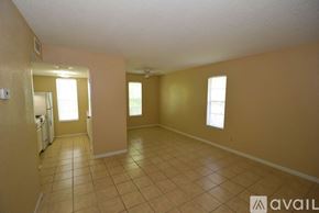 Corpus Christi apartment for rent - A spacious room with tile flooring and a few windows.