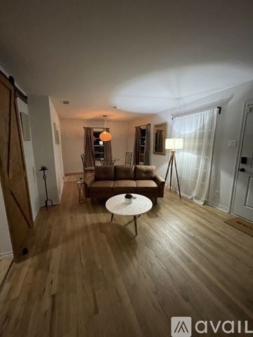 Irving house for rent - A living room with a brown sofa and a white coffee table.