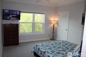 Charleston apartment for rent - A bedroom with a bed, dresser, and window.