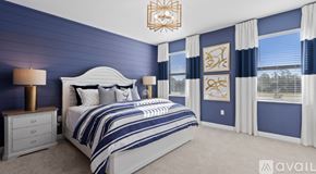 Naples house for rent - A bedroom with a large bed and a chandelier.