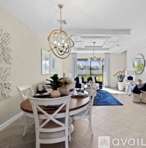 Naples house for rent - A dining room with a wooden table and white chairs.