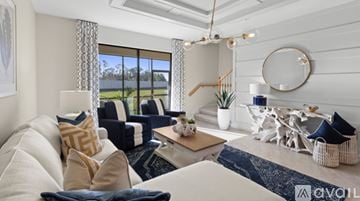 Naples house for rent - A living room with a white couch and a blue rug.