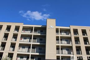 Charleston apartment for rent - A tall building with balconies and a logo on the side.