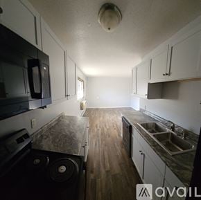 La Crosse apartment for rent - A beige house with a white car parked in front.