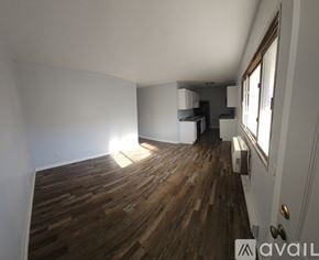 La Crosse apartment for rent - A room with wooden flooring and a window.