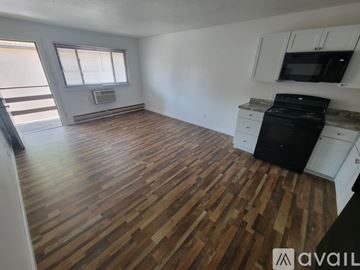 La Crosse apartment for rent - A kitchen with white cabinets and a black stove top oven.