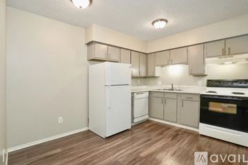 Longmont apartment for rent - A kitchen with white appliances and wooden floors.