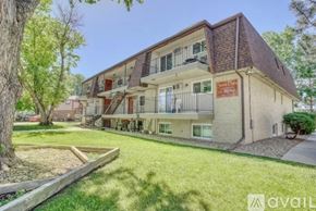 Longmont apartment for rent - A building with a brown roof and a sign that says "available" in front of it.