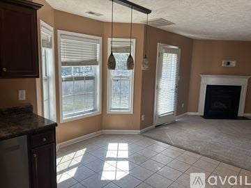 Fayetteville house for rent - A kitchen with brown cabinets and a black countertop.