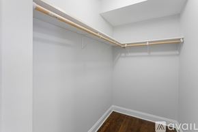Chicago apartment for rent - A white wall with a wooden shelf on top.