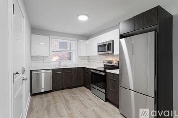 Chicago apartment for rent - A kitchen with a white fridge and a white door.