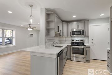 Chicago apartment for rent - A modern kitchen with stainless steel appliances and wooden floors.