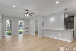 Chicago apartment for rent - A spacious room with a ceiling fan and pendant lights.