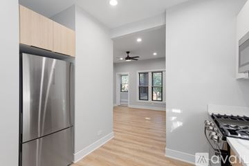 Chicago apartment for rent - A modern kitchen with a stainless steel refrigerator and wooden flooring.