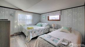 Wells house for rent - A bedroom with two beds and a dresser.