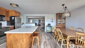 Wells house for rent - A kitchen with wooden cabinets and a wooden island with a bar stool.