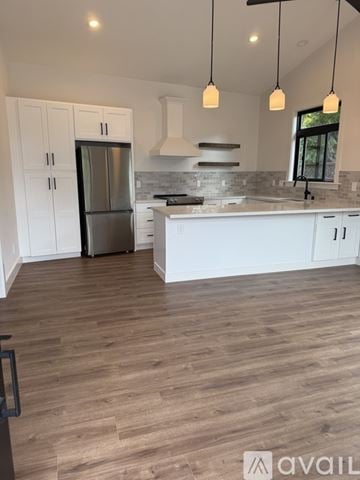 Los Gatos house for rent - A kitchen with white cabinets and a wooden floor.
