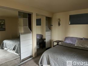 Anchorage apartment for rent - A bedroom with two beds and a mirrored wardrobe.