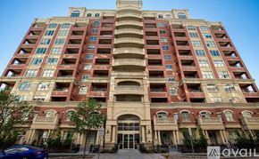 Denver condo for rent - A tall apartment building with a blue car parked in front.