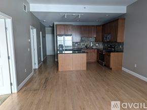 Denver condo for rent - A kitchen with wooden floors and a countertop.