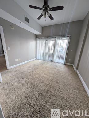 Denver condo for rent - A room with a carpeted floor and a ceiling fan.